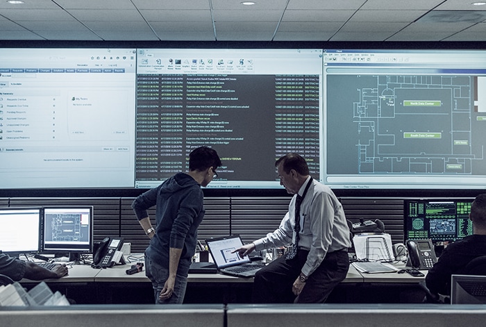 men in computer control room